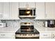 Kitchen showcasing white cabinets, stainless steel appliances, and elegant marble-look countertops at 2700 Bayshore Blvd # 544, Dunedin, FL 34698