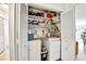 Laundry closet featuring washer, dryer, and organized shelving for storage at 2700 Bayshore Blvd # 544, Dunedin, FL 34698