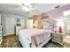 Comfortable bedroom featuring an accent wall, ceiling fan, and laminate flooring at 2700 Bayshore Blvd # 544, Dunedin, FL 34698