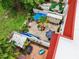 Aerial view of a brick paved patio featuring patio furniture, landscaping, a small storage shed, and umbrellas at 2700 Bayshore Blvd # 544, Dunedin, FL 34698