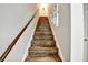 Staircase with wood-look steps leading to the upper level of the home at 2700 Bayshore Blvd # 544, Dunedin, FL 34698