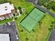 Aerial shot of a well-maintained community tennis court surrounded by mature trees and landscaping at 2700 Bayshore Blvd # 544, Dunedin, FL 34698