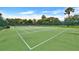 Well-maintained community tennis court with new surfacing, surrounded by mature landscaping at 2700 Bayshore Blvd # 544, Dunedin, FL 34698