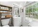 Bright bathroom featuring a framed mirror, storage shelves, and large window at 2809 W Platt St # 6, Tampa, FL 33609