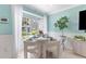 Cozy dining area by a bay window with a round table and modern chairs filled with natural light at 2809 W Platt St # 6, Tampa, FL 33609
