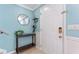 Welcoming foyer with light blue walls, a stylish round mirror, and a convenient console table at 2809 W Platt St # 6, Tampa, FL 33609