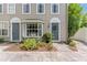 Inviting townhouse showcasing the front entry with a blue door, floral wreath, and a charming bay window at 2809 W Platt St # 6, Tampa, FL 33609
