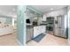Charming kitchen featuring stainless steel appliances, granite countertops, and white cabinetry at 2809 W Platt St # 6, Tampa, FL 33609