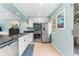 Well-lit kitchen with stainless steel appliances, granite countertops, and access to the patio at 2809 W Platt St # 6, Tampa, FL 33609