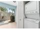 Convenient laundry room with a stacked washer and dryer unit and access to the patio at 2809 W Platt St # 6, Tampa, FL 33609
