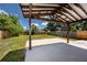 View of the wooden-fenced backyard showing the covered patio and the lush green grass at 2859 38Th N Ave, St Petersburg, FL 33713