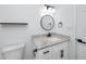 Bathroom features white vanity with granite countertops, black hardware and modern fixtures at 2859 38Th N Ave, St Petersburg, FL 33713