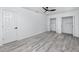 Bright bedroom features light gray wood look floors, a ceiling fan, and walk-in closets at 2859 38Th N Ave, St Petersburg, FL 33713