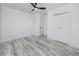 Clean bedroom features hardwood floors, closet with bi-fold doors and modern ceiling fan at 2859 38Th N Ave, St Petersburg, FL 33713