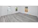 A bright bedroom featuring wood-look floors, white walls, and ample natural light from two windows at 2859 38Th N Ave, St Petersburg, FL 33713