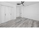 Clean bedroom features hardwood floors, closet with bi-fold doors and modern ceiling fan at 2859 38Th N Ave, St Petersburg, FL 33713