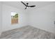Bright bedroom features neutral walls, modern ceiling fan, and a window view of the outdoors at 2859 38Th N Ave, St Petersburg, FL 33713