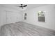 Spacious bedroom with light gray wood look floors, large closets and two windows at 2859 38Th N Ave, St Petersburg, FL 33713
