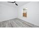 Bright bedroom features neutral walls, modern ceiling fan, and a window view of the outdoors at 2859 38Th N Ave, St Petersburg, FL 33713