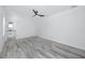 Large bedroom with light gray wood look floors, ceiling fan and en suite bathroom at 2859 38Th N Ave, St Petersburg, FL 33713
