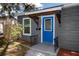 Charming home featuring a vibrant blue front door and well-maintained landscaping at 2859 38Th N Ave, St Petersburg, FL 33713