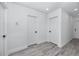 Bright hallway featuring several doors and light gray wood look floors at 2859 38Th N Ave, St Petersburg, FL 33713