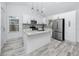 Bright kitchen with a granite island, modern stainless steel appliances, and stylish backsplash at 2859 38Th N Ave, St Petersburg, FL 33713