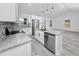 Bright, modern kitchen with white cabinets, stainless steel appliances, and granite countertops offers style and functionality at 2859 38Th N Ave, St Petersburg, FL 33713
