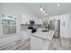 A modern white kitchen is displayed with granite countertops, stainless steel appliances and a stylish backsplash at 2859 38Th N Ave, St Petersburg, FL 33713
