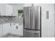 A modern kitchen with white cabinets, stainless steel appliances, granite countertops, and stylish backsplash at 2859 38Th N Ave, St Petersburg, FL 33713