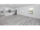 Bright and open living room showcasing wood floors and white walls with kitchen in view at 2859 38Th N Ave, St Petersburg, FL 33713
