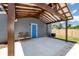 Covered patio features a blue door, wood beams and an outdoor seating area at 2859 38Th N Ave, St Petersburg, FL 33713
