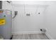 A utility room features a water heater, white walls and light grey wood look floors at 2859 38Th N Ave, St Petersburg, FL 33713