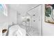 Bright bathroom featuring a soaking tub, glass-enclosed shower, and white cabinetry at 2918 N 21St St, Tampa, FL 33605