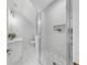 White bathroom featuring shower with subway tile, pebble floor, and glass surround at 2918 N 21St St, Tampa, FL 33605