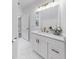 Bright bathroom with white cabinets, quartz counters, gold hardware, and hexagonal tile floors at 2918 N 21St St, Tampa, FL 33605