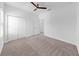 Spacious bedroom featuring a ceiling fan, carpet flooring, and a double-door closet at 2918 N 21St St, Tampa, FL 33605