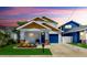 Charming home featuring a colorful front door, landscaped yard, and a one car garage at 2918 N 21St St, Tampa, FL 33605
