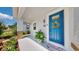 Inviting front porch featuring a vibrant blue door, welcoming wreath, and decorative plant at 2918 N 21St St, Tampa, FL 33605