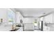 Bright kitchen with stainless steel appliances, tile flooring, quartz countertops, and modern white cabinetry at 2918 N 21St St, Tampa, FL 33605