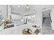 Bright kitchen with quartz countertops, stainless steel appliances, tile flooring, and a breakfast bar with seating at 2918 N 21St St, Tampa, FL 33605