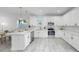 Bright kitchen featuring white cabinets, quartz countertops, and stainless steel appliances at 2918 N 21St St, Tampa, FL 33605