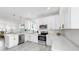 Open concept kitchen features stainless appliances, marble countertops, and white cabinets at 2918 N 21St St, Tampa, FL 33605