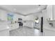 This kitchen features white cabinets, stainless steel appliances, and marble countertops at 2918 N 21St St, Tampa, FL 33605