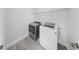 Laundry room featuring a gray dryer and a white washing machine with gray tile flooring at 2918 N 21St St, Tampa, FL 33605