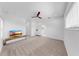 This main bedroom offers carpet flooring, a ceiling fan, and access to the ensuite bathroom at 2918 N 21St St, Tampa, FL 33605