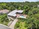 Aerial view showcasing a home with a pool, well-maintained landscaping, and a private, fenced backyard at 3012 Grand View Ave, Clearwater, FL 33759
