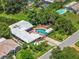 Aerial view of property featuring a private pool, fenced yard, and mature landscaping at 3012 Grand View Ave, Clearwater, FL 33759
