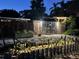 Fenced in backyard with mature plants and decorative solar lights at 3012 Grand View Ave, Clearwater, FL 33759