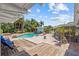 Backyard pool and paver deck with adjacent wood decks and lush tropical landscaping at 3012 Grand View Ave, Clearwater, FL 33759
